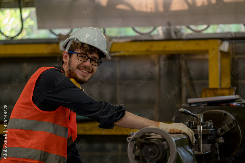 Poster technician workers are turning iron,engineer control operating lathe grinding machine working in ind