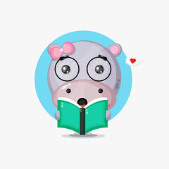 Cute hippo is reading a book