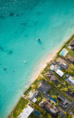 Ocean shore Aerial view, Top view, amazing nature background. Clearwater of Hawaii ocean on a sunny day. flying drone, sea view with houses and boats