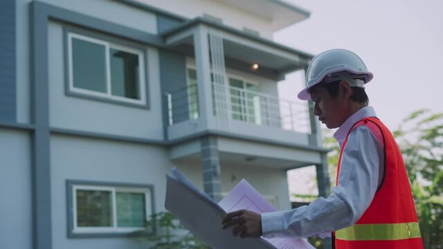 Contractor is inspecting the house with reference to the construction standards. Engineers are doing final checks before delivering to clients. The construction concept is Refer standard.