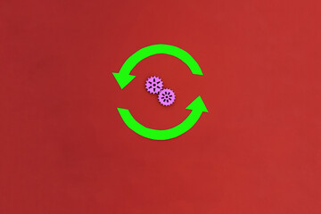 Two rounded green arrows, two purple gears on a red background. The concept of the mechanism of movement, interaction.