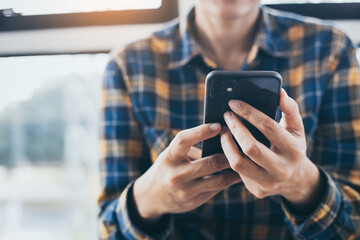 using cell phone hand holding mobile texting message contact us.chatting,search internet...