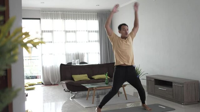 asian Fit Young Man Exercise on Mat at home. stretching and workout by himself