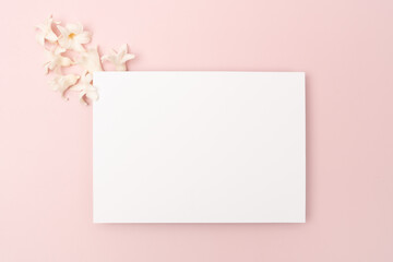 White blank stationery flat lay with hyacinth on pink background