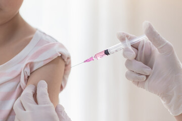Asian child receiving injection or vaccine