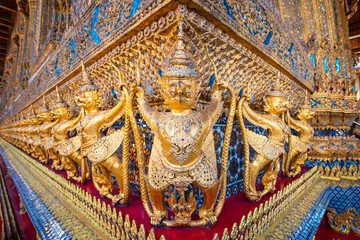 Fototapeta na wymiar Details on the base of the Wat Phra Kaew's main hall - a sacred temple whic is a part of the Thai grand palace, where it houses an ancient Emerald Buddha