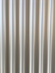 Corrugated siding with vertical stripes reflecting diffuse light