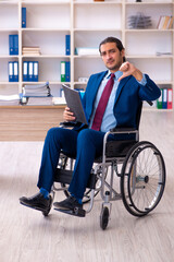 Young disabled employee working in the office