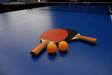 on the tennis table is a ball and table tennis racket.