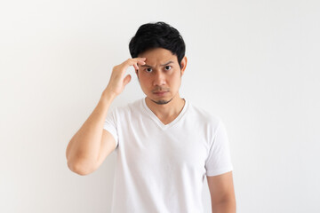 Serious and upset Asian man wears white t-shirt isolated on white background.