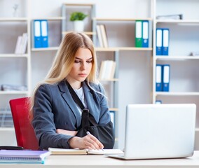 Injured female employee working in the office