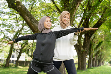 happy muslim with exercising partner doing sport together outdoor