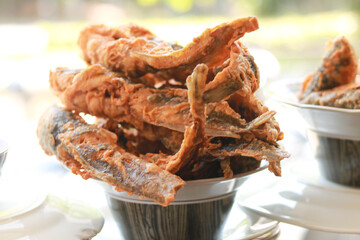 Deep fried catfish in white plate.