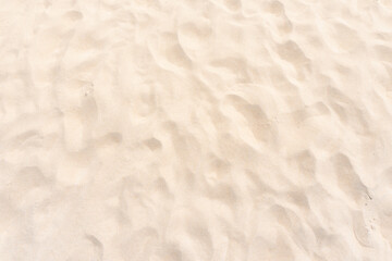 Fototapeta na wymiar sand texture in sunny summer sun. Wallpaper and background concept.