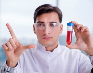 Man doctor checking blood samples in lab