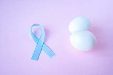 prostate cancer, healthcare, profession, medicine concept - close up of chicken white eggs and blue...