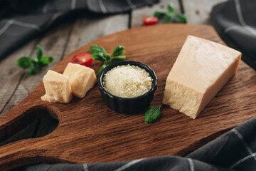 Italian cuisine concept. Parmesan Cheese chunks, cherry tomatos, basil leaves