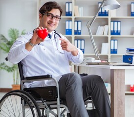 Disabled doctor on wheelchair working in hospital
