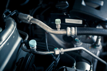 Fototapeta premium details of car engine, air-conditioning hoses and fittings, internal combustion engine, old film look effect, shallow depth of field