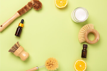 Eco friendly cleaning products and tools. Wooden bamboo brushes, baking soda, lemon, essential oils, vinegar. Top view - Image