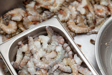 Many peeled raw headless large shrimps without shell
