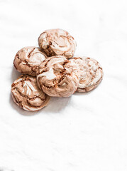 Chocolate meringue on a light background, top view. Copy space