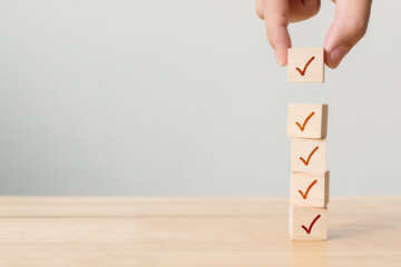 Checklist concept, Check mark on wooden blocks on table with copy space