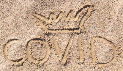 Inscription on the sand covid-19