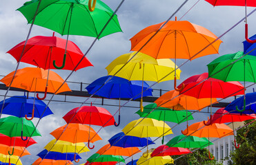 Fototapeta na wymiar Beautiful colorful umbrellas. Street decoration with umbrellas. Lots of colorful umbrellas in the central square.