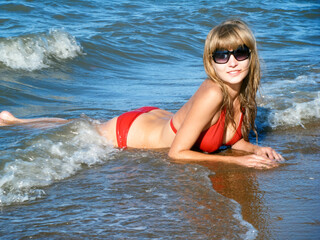 Beautiful Girl in a swimsuit in the sea. Marine Landscape