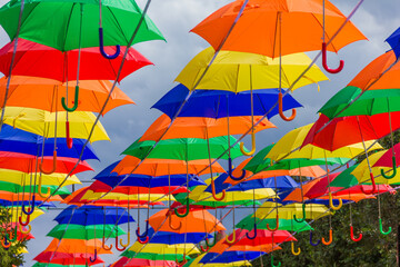 Beautiful colorful umbrellas. Street decoration with umbrellas. Lots of colorful umbrellas in the central square.