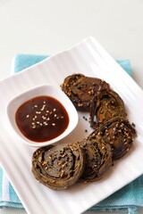 Alu Vadi, Patra, paatra, colocasia leaves roll, Patrode is a popular Indian healthy steamed snack. Garnished with sesame and mustard seeds. served with tamarind chutney. copy space.