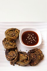 Alu Vadi, Patra, paatra, colocasia leaves roll, Patrode is a popular Indian healthy steamed snack. Garnished with sesame and mustard seeds. served with tamarind chutney. copy space.