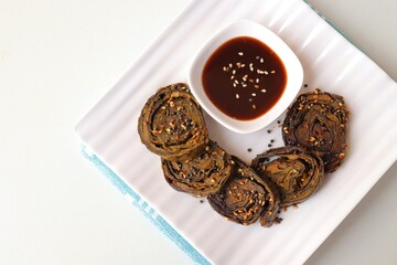 Alu Vadi, Patra, paatra, colocasia leaves roll, Patrode is a popular Indian healthy steamed snack. Garnished with sesame and mustard seeds. served with tamarind chutney. copy space.