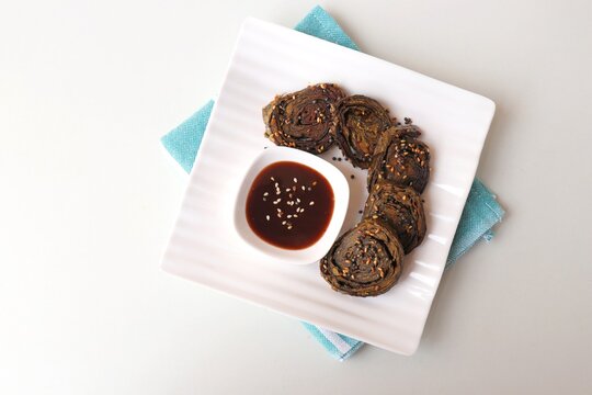 Alu Vadi, Patra, paatra, colocasia leaves roll, Patrode is a popular Indian healthy steamed snack. Garnished with sesame and mustard seeds. served with tamarind chutney. copy space.