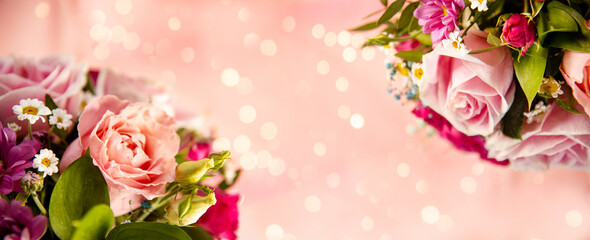 Banner summer bouquet of flowers close-up on a light pink background with beautiful bokeh, free space for text. Bouquet of pink roses and daisies, soft focus