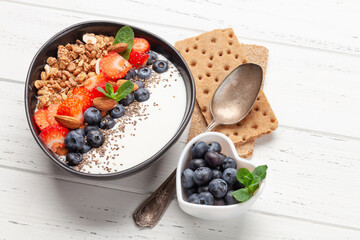 Healthy breakfast with bowl of granola, yogurt and fresh berries