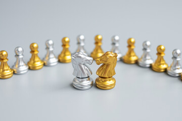 Gold and silver Chess Knight (horse) figure against pawn. Strategy, Conflict, management, business planning, tactic, politic, communication and leader concept