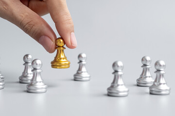 hand holding golden chess pawn pieces or leader businessman with of silver men. victory,...