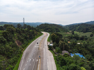 Asphalt road through mountain and forest
