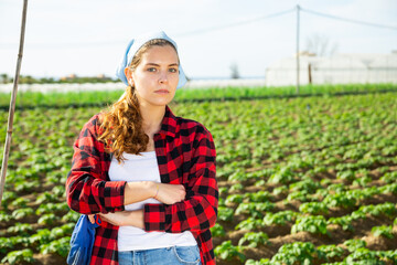 Portrait of positive young woman enjoying favourite pastime of gardening