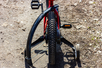 Children's broken bike on a forest road. A bike with a broken fender.
