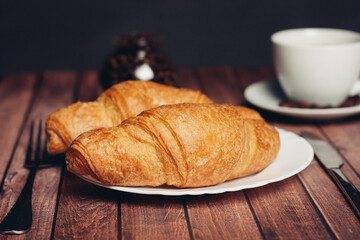 crispy croissants on a plate kitchen utensils for breakfast 