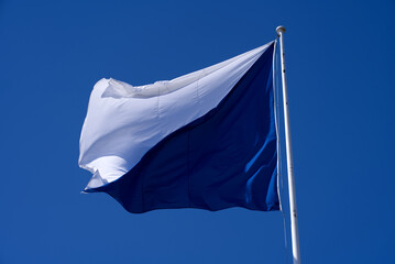 Flag of City of Z&uuml;rich and Canton Z&uuml;rich waving at City of Z&uuml;rich on a sunny spring day. Photo taken April 4th, 2021, Zurich, Switzerland.