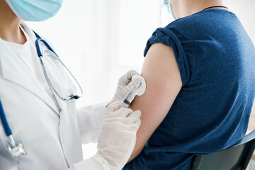 woman doctor giving an injection in the shoulder Patient laboratory assistant vaccine