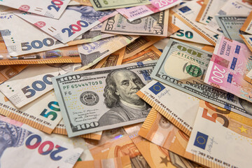 Obraz na płótnie Canvas Money from different countries hryvnia, dollars and euros