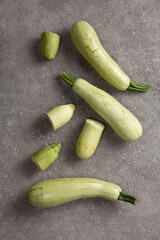 Fresh zucchini on a gray concrete background.