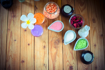 Colorful of  Salt scrub and body sand, Compress used for skin care, set on a wooden table. Spa composition.