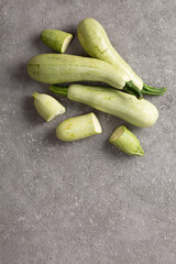 Fresh zucchini on a gray concrete background.