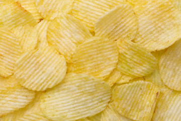 Close-up of potato ribbed chips. Chips background